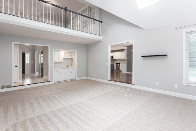 833 Moon Glow Ct, Columbus, OH 43230 - unfurnished living room with light colored carpet and a towering ceiling
