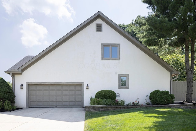 833 Moon Glow Ct, Columbus, OH 43230 - view of side of home featuring stucco siding, concrete driveway, a lawn, and an attached garage