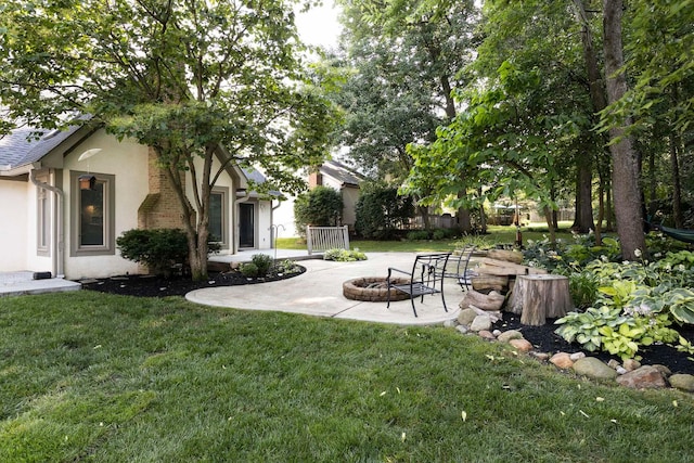 833 Moon Glow Ct, Columbus, OH 43230 - view of green lawn with an outdoor fire pit and a patio