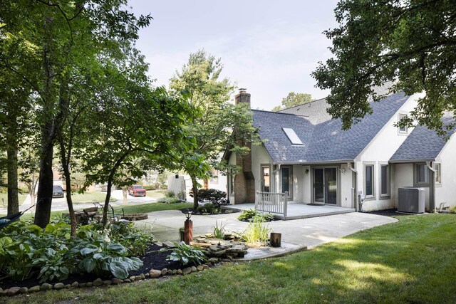 833 Moon Glow Ct, Columbus, OH 43230 - rear view of property featuring a chimney, roof with shingles, stucco siding, a lawn, and a patio