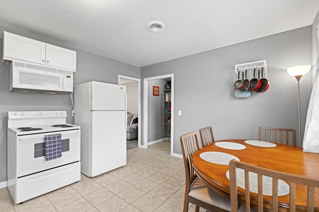 507 Shoshone Dr, Lancaster, OH 43130 - kitchen with white appliances, light tile patterned floors, and white cabinets