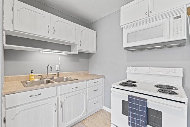 507 Shoshone Dr, Lancaster, OH 43130 - kitchen featuring white appliances, white cabinetry, light tile patterned floors, and light countertops