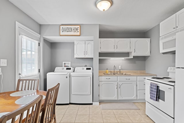 507 Shoshone Dr, Lancaster, OH 43130 - kitchen featuring white appliances, washing machine and clothes dryer, white cabinetry, light tile patterned flooring, and light countertops