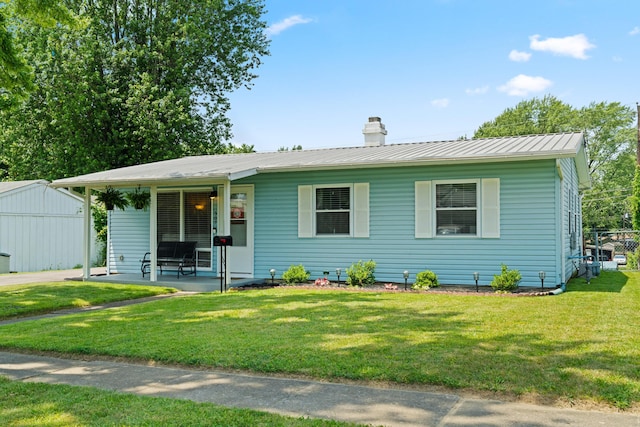 507 Shoshone Dr, Lancaster, OH 43130 - view of front facade with a front yard, a chimney, a metal roof, and a standing seam roof