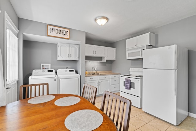 507 Shoshone Dr, Lancaster, OH 43130 - kitchen featuring white appliances, washing machine and dryer, white cabinetry, light tile patterned floors, and light countertops
