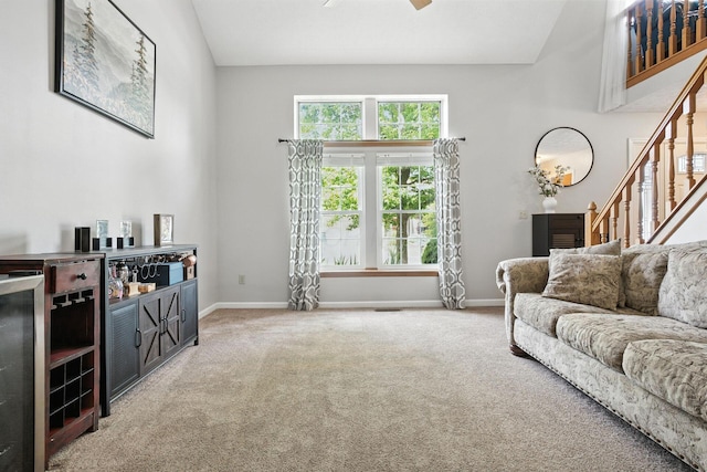 1126 Welwyn Dr, Westerville, OH 43081 - living room with carpet flooring, stairway, and ceiling fan
