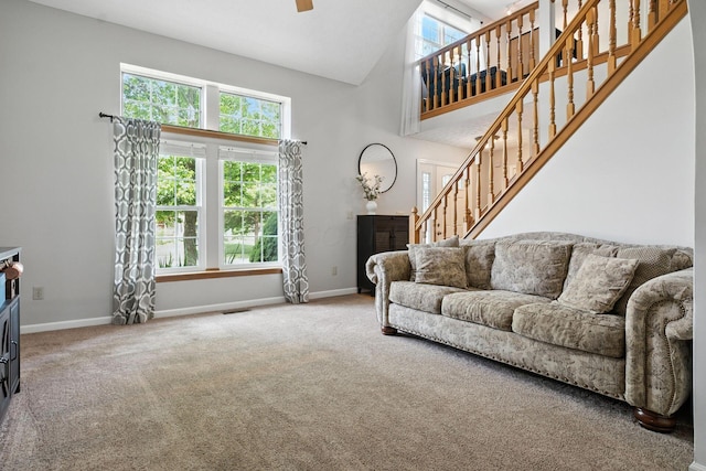 1126 Welwyn Dr, Westerville, OH 43081 - carpeted living room with high vaulted ceiling, stairs, plenty of natural light, and a ceiling fan