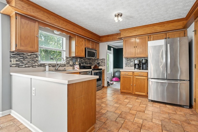 1126 Welwyn Dr, Westerville, OH 43081 - kitchen featuring appliances with stainless steel finishes, light countertops, decorative backsplash, a peninsula, and crown molding
