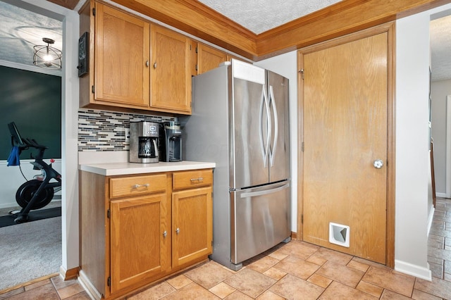 1126 Welwyn Dr, Westerville, OH 43081 - kitchen featuring freestanding refrigerator, light countertops, decorative backsplash, ornamental molding, and light stone finish flooring