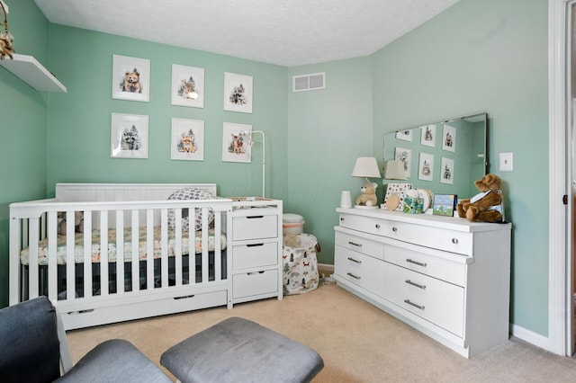 1126 Welwyn Dr, Westerville, OH 43081 - bedroom featuring a nursery area, light carpet, and a textured ceiling