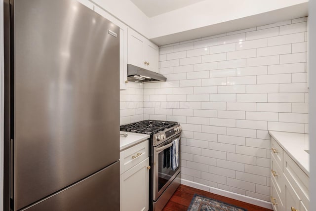 249 E Kossuth St Unit E, Columbus, OH 43206 - kitchen with stainless steel appliances, under cabinet range hood, light countertops, dark wood-style flooring, and tile walls