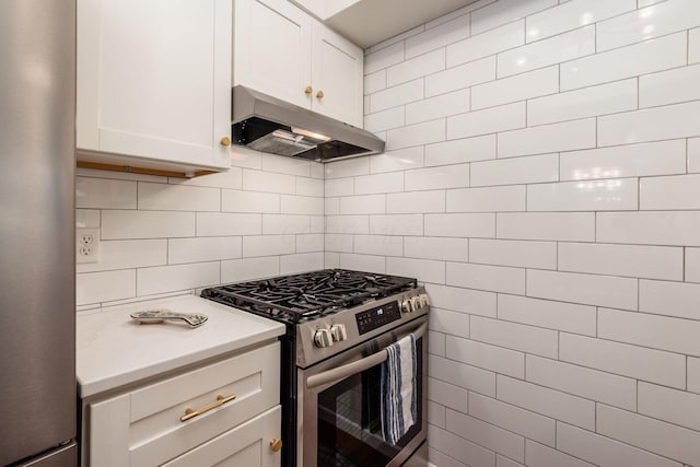 249 E Kossuth St Unit E, Columbus, OH 43206 - kitchen with appliances with stainless steel finishes, under cabinet range hood, light countertops, tasteful backsplash, and white cabinetry