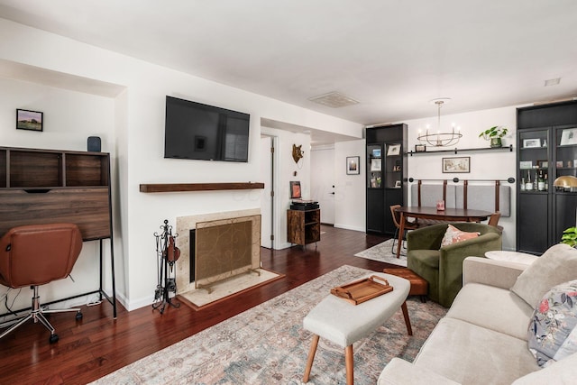 249 E Kossuth St Unit E, Columbus, OH 43206 - living area with wood finished floors, a chandelier, and a fireplace