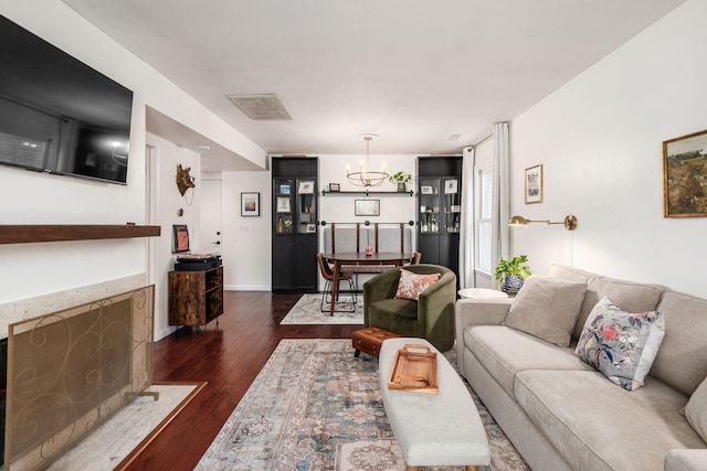 249 E Kossuth St Unit E, Columbus, OH 43206 - living area with dark wood-type flooring, a chandelier, and a high end fireplace