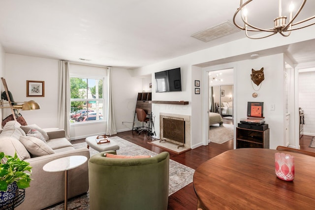 249 E Kossuth St Unit E, Columbus, OH 43206 - living area with a chandelier, a fireplace, and dark wood-style flooring