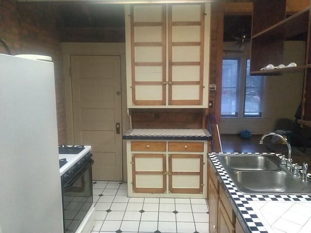 867-871 Delaware Ave, Columbus, OH 43215 - kitchen with range, tile countertops, freestanding refrigerator, and light tile patterned floors