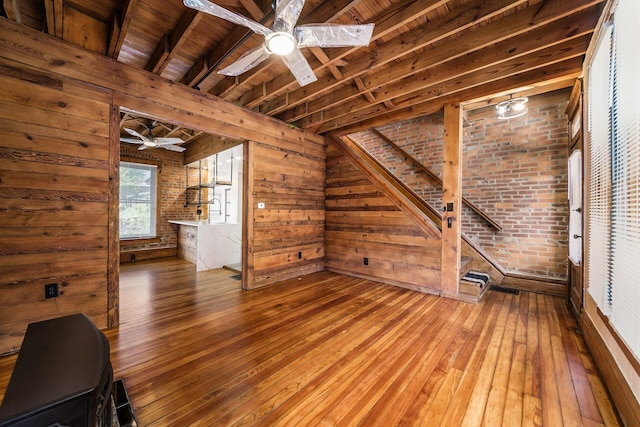 867-871 Delaware Ave, Columbus, OH 43215 - unfurnished living room featuring a ceiling fan, hardwood / wood-style floors, wooden walls, and a wooden ceiling with exposed beams