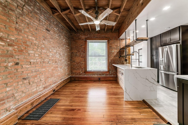 867-871 Delaware Ave, Columbus, OH 43215 - kitchen featuring stainless steel refrigerator with ice dispenser, a wood ceiling with exposed beams, brick wall, light wood finished floors, and a ceiling fan