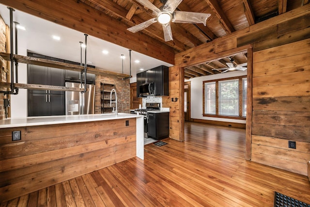 867-871 Delaware Ave, Columbus, OH 43215 - kitchen featuring a ceiling fan, appliances with stainless steel finishes, light countertops, a wood ceiling with exposed beams, and hardwood / wood-style flooring