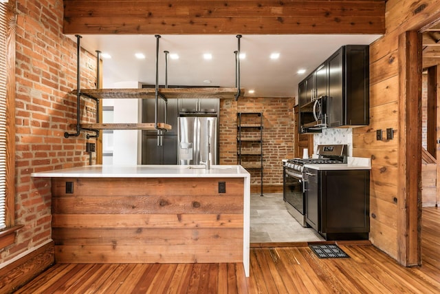 867-871 Delaware Ave, Columbus, OH 43215 - kitchen featuring stainless steel appliances, light wood-style floors, dark cabinetry, and light countertops