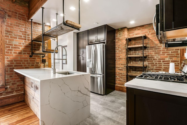 867-871 Delaware Ave, Columbus, OH 43215 - kitchen with stainless steel refrigerator with ice dispenser, light stone countertops, a peninsula, brick wall, and gas stovetop