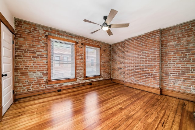 867-871 Delaware Ave, Columbus, OH 43215 - spare room featuring brick wall, light wood finished floors, and ceiling fan