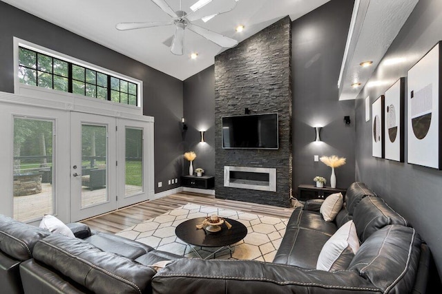 10382 Wright Rd NW, Canal Winchester, OH 43110 - living area featuring high vaulted ceiling, a ceiling fan, a stone fireplace, wood finished floors, and french doors