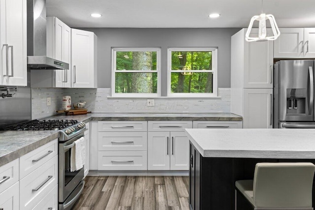 10382 Wright Rd NW, Canal Winchester, OH 43110 - kitchen featuring appliances with stainless steel finishes, wall chimney exhaust hood, white cabinets, tasteful backsplash, and recessed lighting