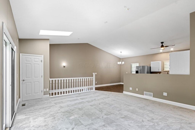 10382 Wright Rd NW, Canal Winchester, OH 43110 - unfurnished room with a chandelier, a skylight, lofted ceiling, a ceiling fan, and carpet floors