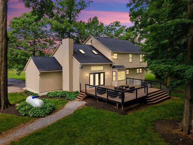 10382 Wright Rd NW, Canal Winchester, OH 43110 - back of house featuring a deck, a yard, a chimney, and french doors