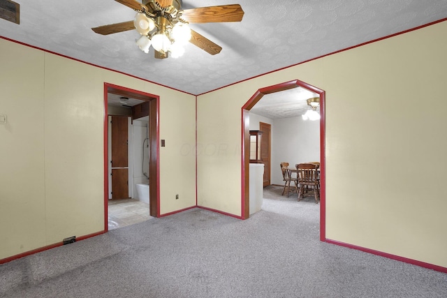 412 E Mill St, Circleville, OH 43113 - carpeted empty room featuring arched walkways, a ceiling fan, and a textured ceiling