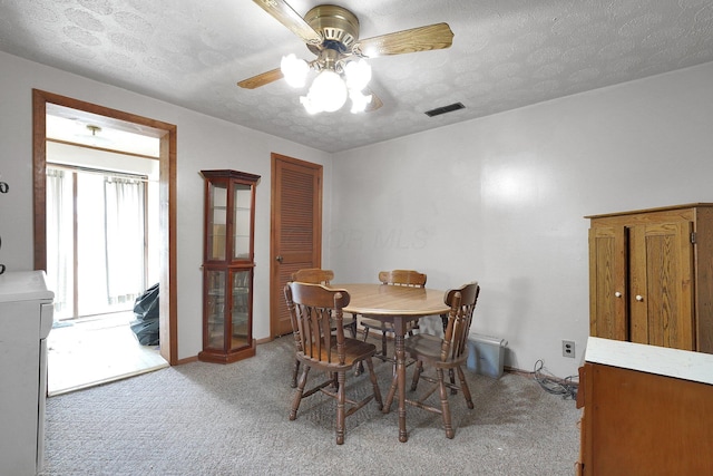 412 E Mill St, Circleville, OH 43113 - dining area with light carpet, a ceiling fan, and a textured ceiling