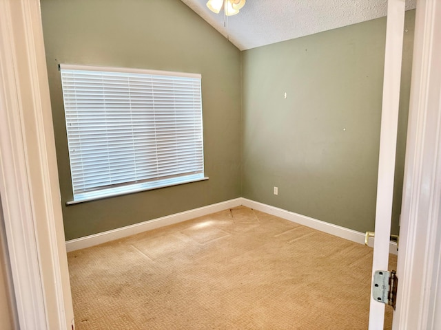 6608 Lakeview Cir, Canal Winchester, OH 43110 - empty room featuring carpet floors, vaulted ceiling, ceiling fan, and a textured ceiling