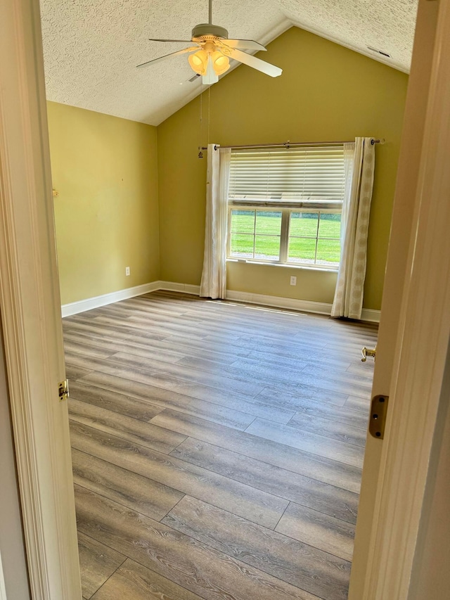 6608 Lakeview Cir, Canal Winchester, OH 43110 - empty room featuring wood-type flooring, a textured ceiling, ceiling fan, and lofted ceiling