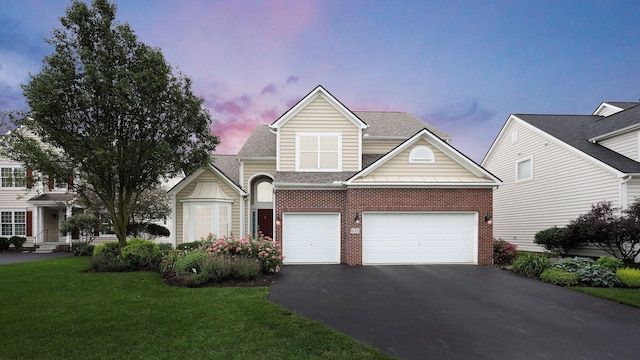 6229 Janes Way, Hilliard, OH 43026 - traditional-style home featuring asphalt driveway, a lawn, brick siding, and a garage