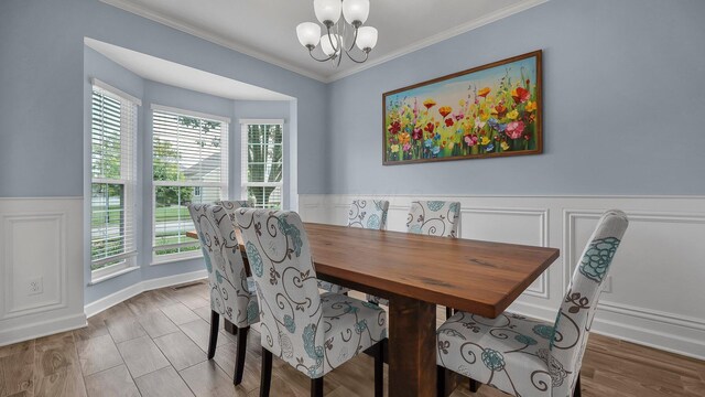 6229 Janes Way, Hilliard, OH 43026 - dining space featuring a chandelier, wainscoting, ornamental molding, and a decorative wall