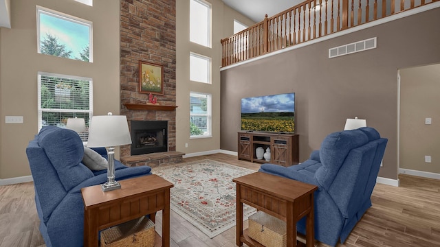 6229 Janes Way, Hilliard, OH 43026 - living area with a towering ceiling, a stone fireplace, and wood finished floors