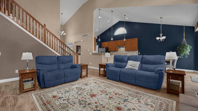 6229 Janes Way, Hilliard, OH 43026 - living area featuring high vaulted ceiling, a chandelier, and stairway
