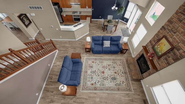 6229 Janes Way, Hilliard, OH 43026 - living area with a high ceiling, a tiled fireplace, and stairs