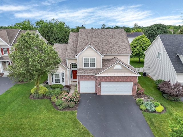 6229 Janes Way, Hilliard, OH 43026 - view of front of property with driveway, brick siding, a front yard, a shingled roof, and an attached garage