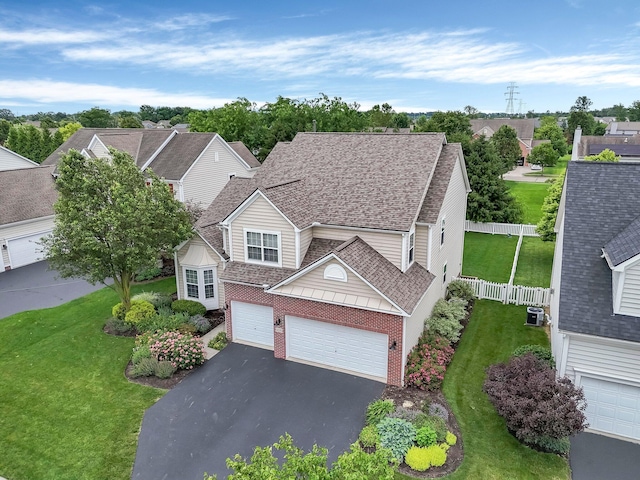 6229 Janes Way, Hilliard, OH 43026 - view of front of property featuring asphalt driveway, brick siding, an attached garage, roof with shingles, and a residential view