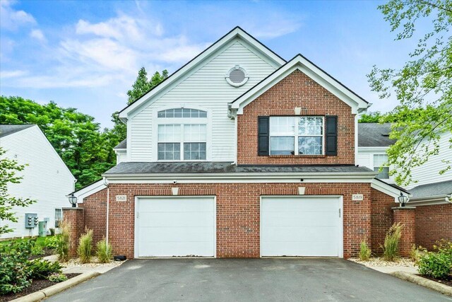 5821 Albany Grv, Westerville, OH 43081 - view of front facade with driveway, a garage, and brick siding
