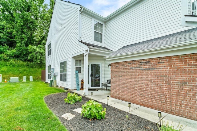 5821 Albany Grv, Westerville, OH 43081 - view of side of property featuring a yard, a patio area, brick siding, and a shingled roof