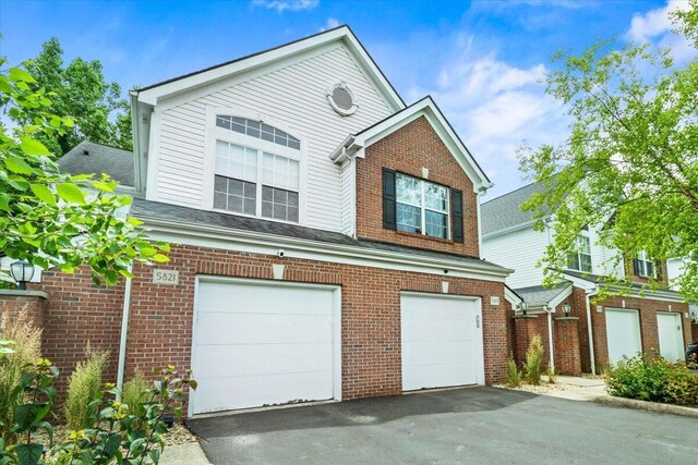 5821 Albany Grv, Westerville, OH 43081 - view of front of property with an attached garage, driveway, and brick siding