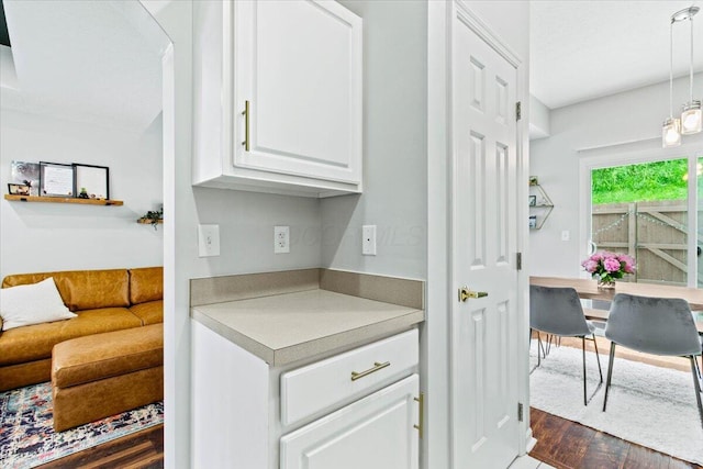 5821 Albany Grv, Westerville, OH 43081 - kitchen with white cabinetry, light countertops, dark wood-style floors, and pendant lighting