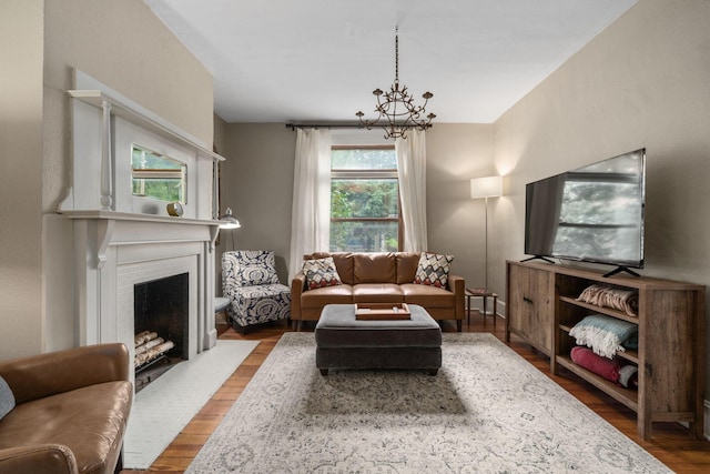 336 E Kossuth St, Columbus, OH 43206 - living room featuring a chandelier, wood finished floors, and a fireplace with flush hearth