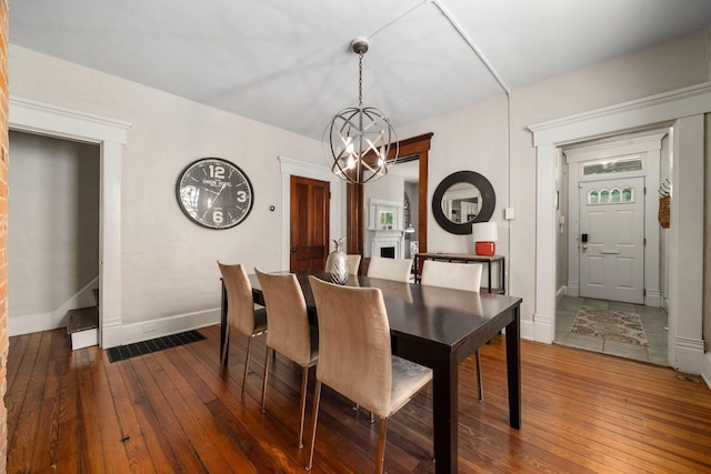 336 E Kossuth St, Columbus, OH 43206 - dining space featuring hardwood / wood-style floors and a chandelier