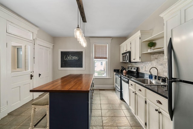 336 E Kossuth St, Columbus, OH 43206 - kitchen featuring butcher block countertops, appliances with stainless steel finishes, open shelves, backsplash, and white cabinetry