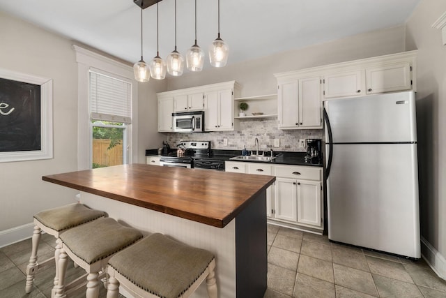 336 E Kossuth St, Columbus, OH 43206 - kitchen with appliances with stainless steel finishes, open shelves, wood counters, and white cabinets