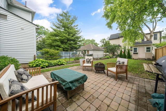 336 E Kossuth St, Columbus, OH 43206 - fenced backyard with a patio area, a storage shed, and an outdoor living space with a fire pit